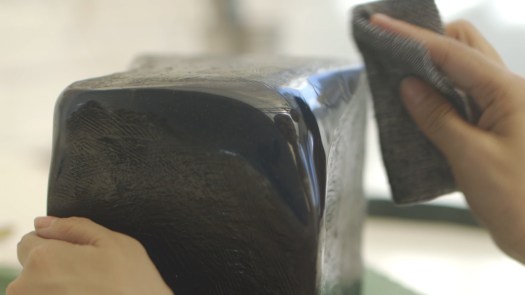 A hand is polishing a device that can hold all of a person's memory.